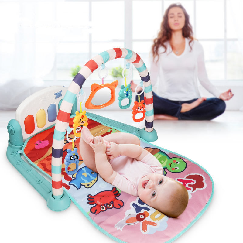 Mother watching baby play on activity gym play mat with piano pedals and sensory arch toys