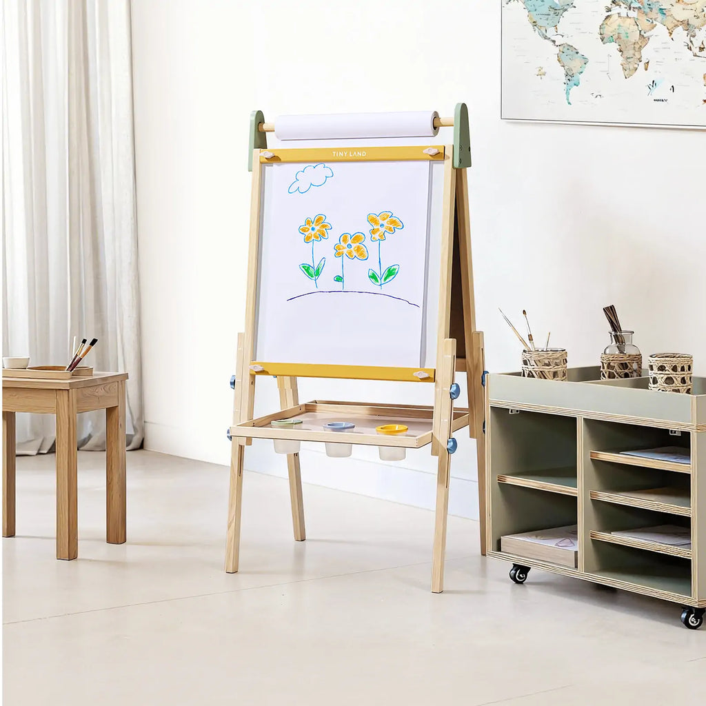 Child painting on Tiny Land art easel outdoors
Tiny Land easel showing full set of drawing tools included