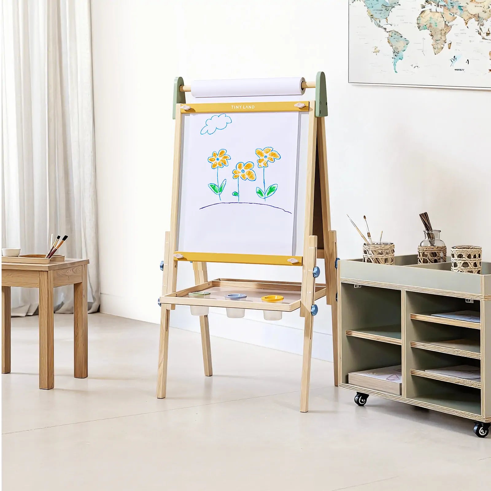 Child painting on Tiny Land art easel outdoors
Tiny Land easel showing full set of drawing tools included
