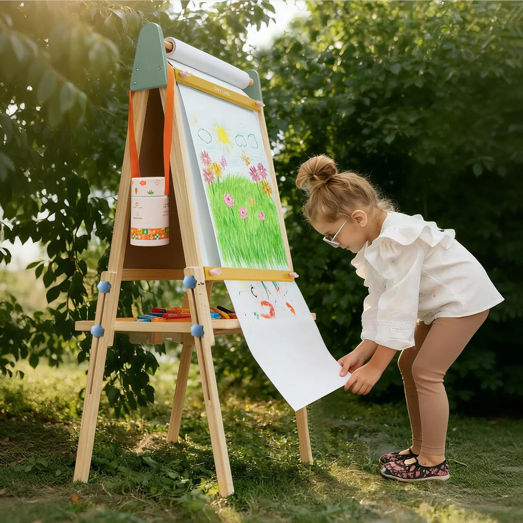 Child painting on Tiny Land art easel outdoors
Tiny Land easel showing full set of drawing tools included