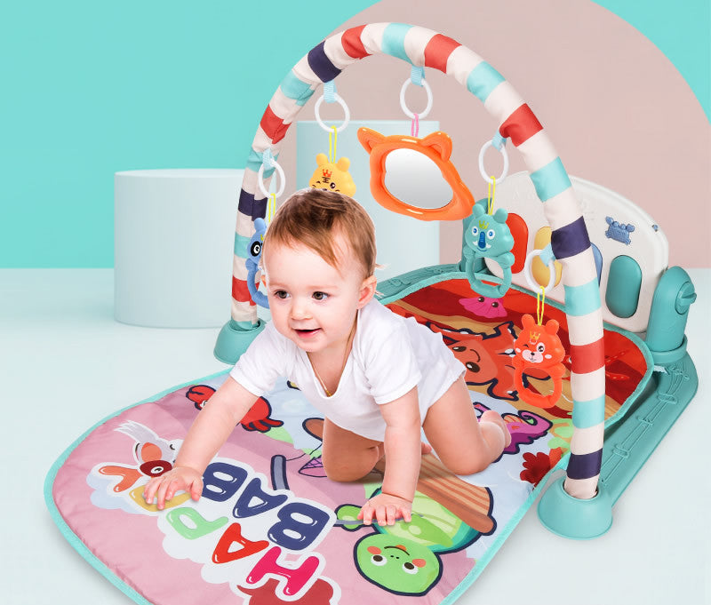 Baby crawling on colorful activity gym play mat with piano kick pedals and hanging sensory toys