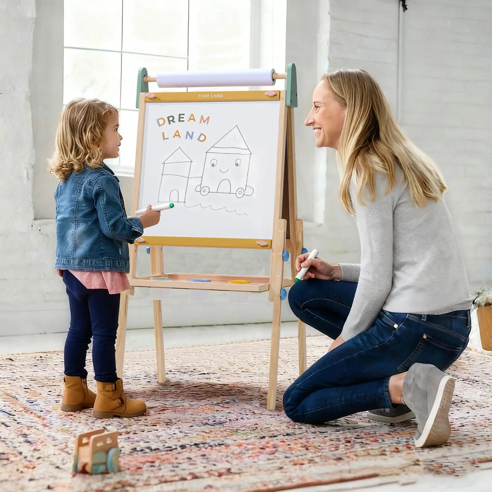 Child painting on Tiny Land art easel outdoors
Tiny Land easel showing full set of drawing tools included