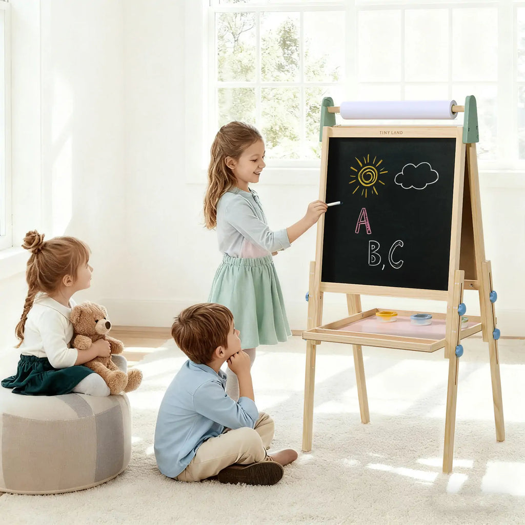 Child painting on Tiny Land art easel outdoors
Tiny Land easel showing full set of drawing tools included