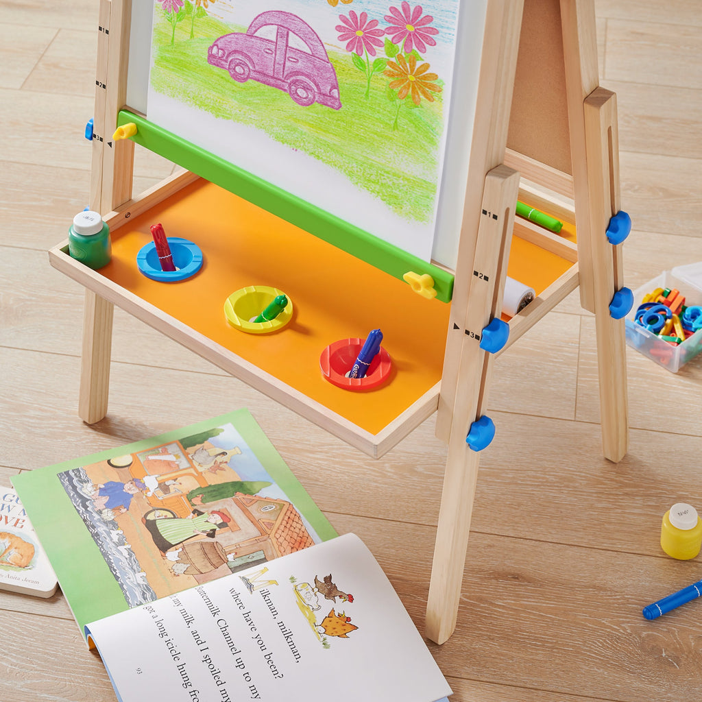 Child painting on Tiny Land art easel outdoors
Tiny Land easel showing full set of drawing tools included