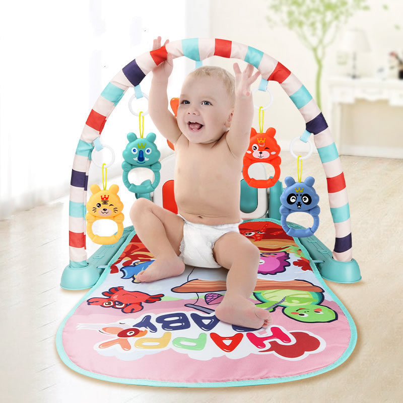 Newborn baby lying on Baby Activity Gym play mat kicking piano pedals with arched frame and hanging toys