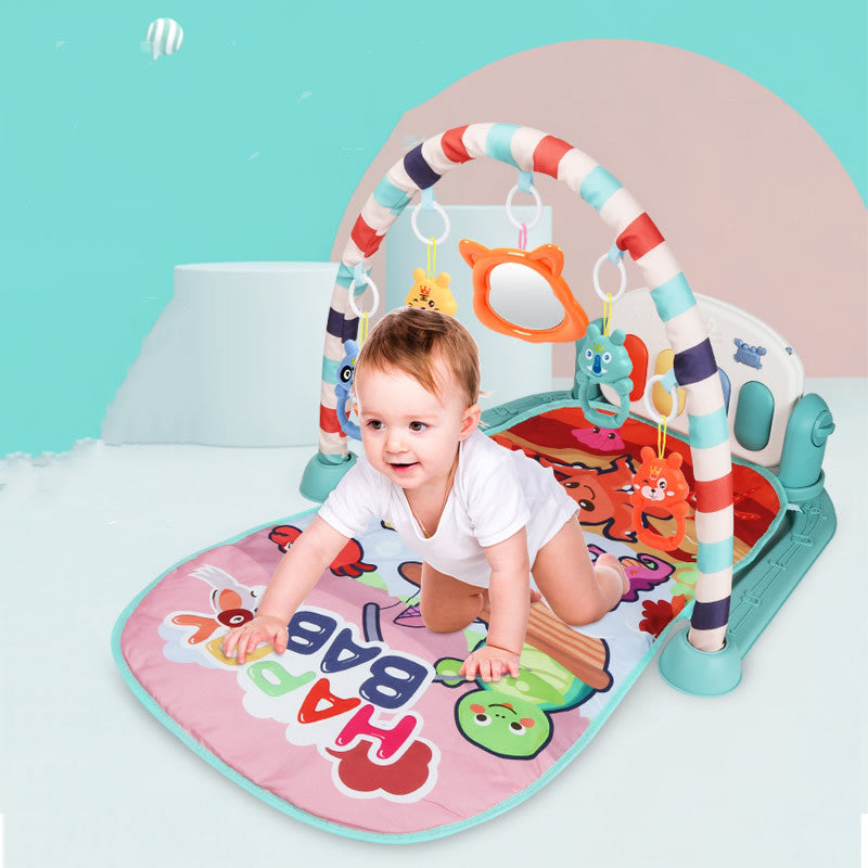 Newborn baby lying on Baby Activity Gym play mat kicking piano pedals with arched frame and hanging toys