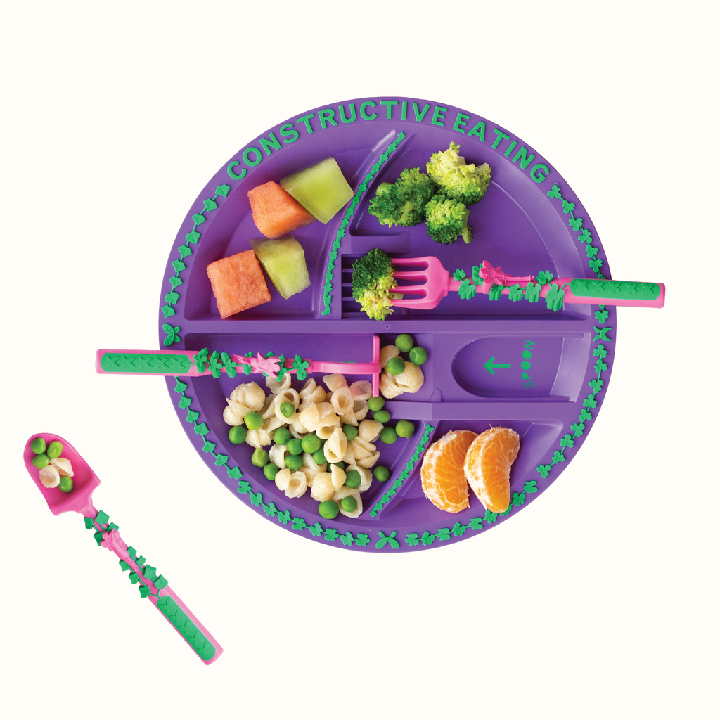 Divided toddler plate with colorful healthy food showing sectioned compartments for self-feeding
